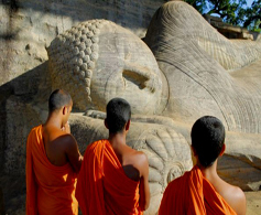 Monks worshiping a stone sculpture of Lord Buddha